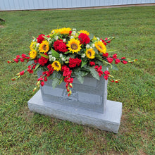 Load image into Gallery viewer, This Headstone Saddle is made with grave flowers including sunflowers and geraniums. It's a memorial decoration..