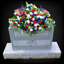 Load image into Gallery viewer, This Headstone Saddle has grave flowers including Red, White, & Blue Mini Mums. It is a perfect Patriotic funeral or cemetery decoration.