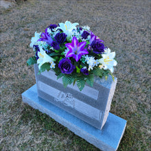 Load image into Gallery viewer, Headstone Saddle with purple & white trumpet lilies and purple roses. It is a grave flower cemetery, funeral, or memorial decoration.