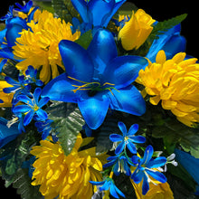 Load image into Gallery viewer, This Headstone Saddle has grave flowers including Vibrant Blue Trumpet Lilies, Bright Yellow Mums, & Rosebuds. It is a memorial decoration.