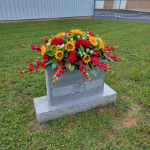 Load image into Gallery viewer, This Headstone Saddle is made with grave flowers including sunflowers and geraniums. It&#39;s a memorial decoration..
