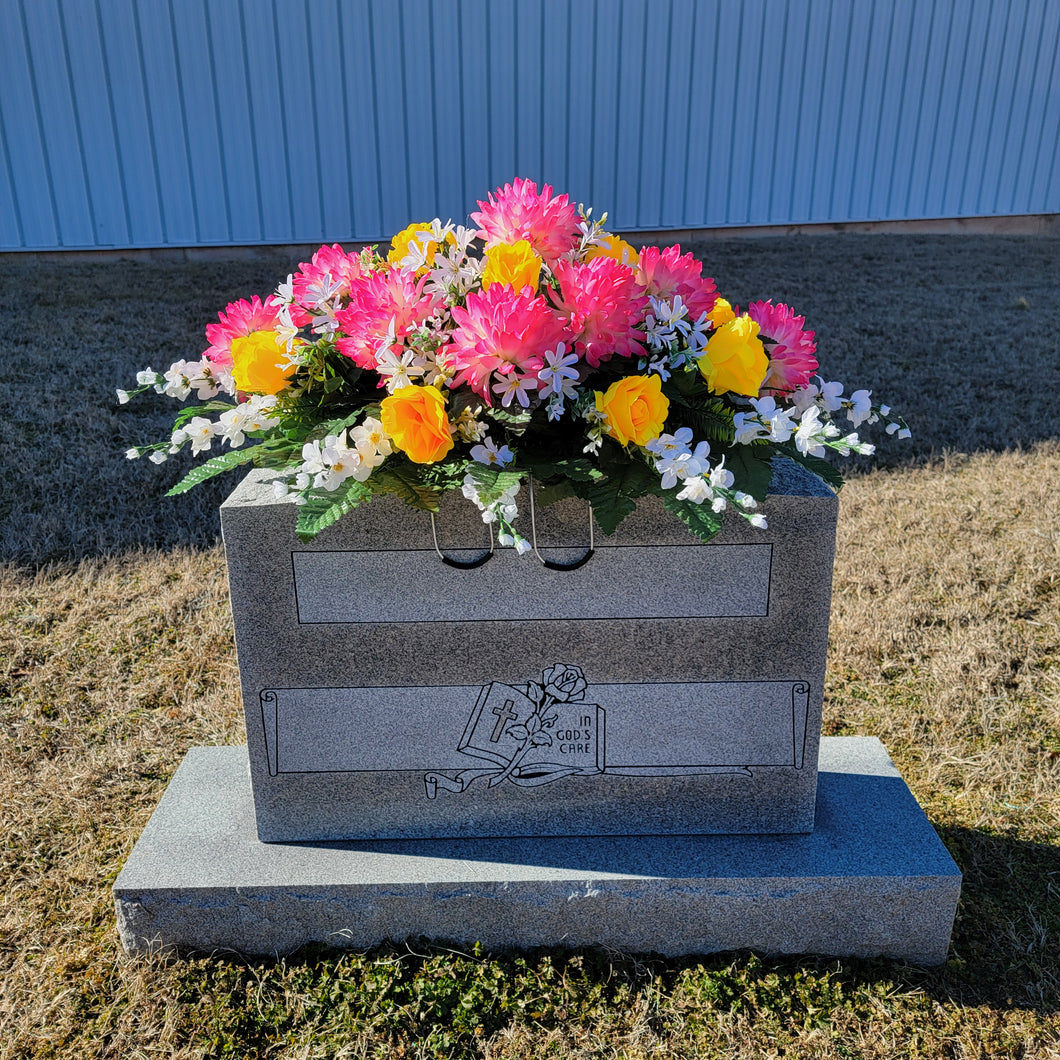 Headstone Saddle with Pink Ball Mums, Yellow Roses, and Cream Larkspur grave flowers for cemetery and memorial decorating.