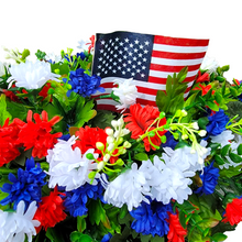 Load image into Gallery viewer, This Headstone Saddle has grave flowers including Red, White, &amp; Blue Mini Mums. It is a perfect Patriotic funeral or cemetery decoration.
