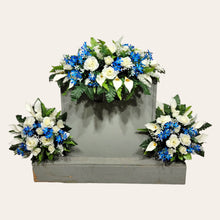 Load image into Gallery viewer, This headstone saddle and cemetery cone set has silk grave flowers including Cream Calla Lilies and Roses and Blue Tweedia.
