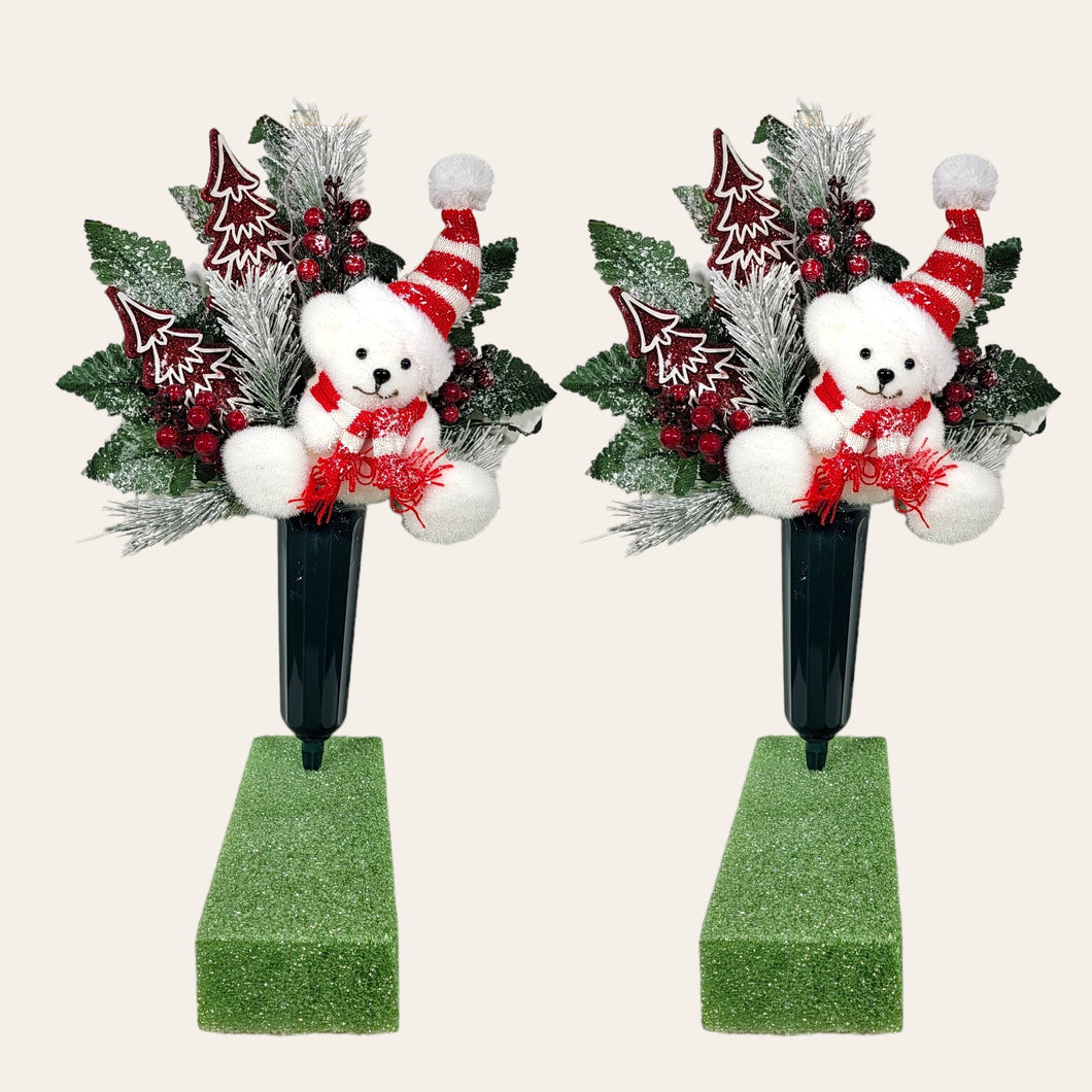 This Christmas memorial cone pair comes with a cute bear, red berries, and red glitter trees. This is cemetery 2 arrangements.