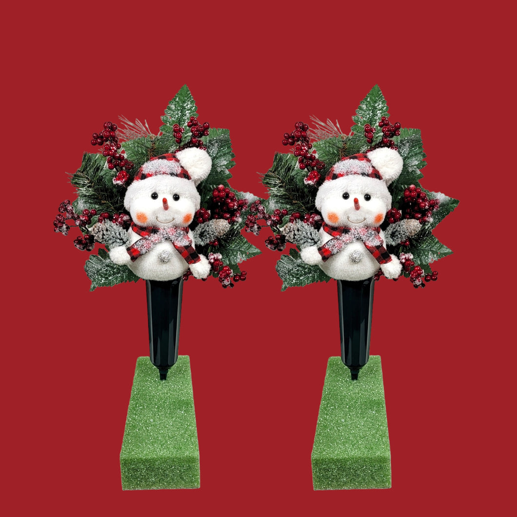 This cemetery cone pair comes with a cute smiling snowman, red berries, and a stocking cap. It is 2 Christmas memorial decorations.