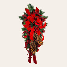 Load image into Gallery viewer, This is a teardrop door hanging that is festive for the Christmas season. It has pinecones, berries, pine, and a cardinal.
