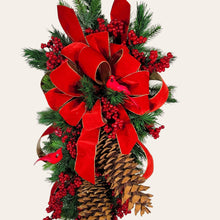 Load image into Gallery viewer, This is a teardrop door hanging that is festive for the Christmas season. It has pinecones, berries, pine, and a cardinal.
