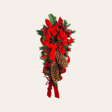 Load image into Gallery viewer, This is a teardrop door hanging that is festive for the Christmas season. It has pinecones, berries, pine, and a cardinal.
