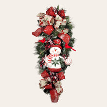 Load image into Gallery viewer, This is a teardrop door hanging that is festive for the Christmas season. It has a snowman, berries, cardinals, and 2 holiday bows.
