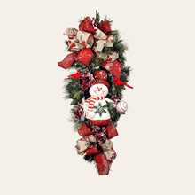 Load image into Gallery viewer, This is a teardrop door hanging that is festive for the Christmas season. It has a snowman, berries, cardinals, and 2 holiday bows.
