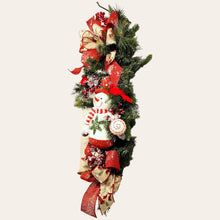 Load image into Gallery viewer, This is a teardrop door hanging that is festive for the Christmas season. It has a snowman, berries, cardinals, and 2 holiday bows.
