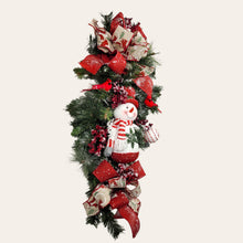 Load image into Gallery viewer, This is a teardrop door hanging that is festive for the Christmas season. It has a snowman, berries, cardinals, and 2 holiday bows.
