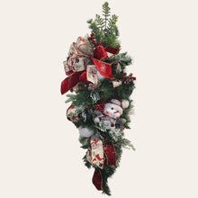 Load image into Gallery viewer, This is a teardrop door hanger that is a festive swag for Christmas season. It has berries, pinecone, snowballs, cute snowman, and a bow.
