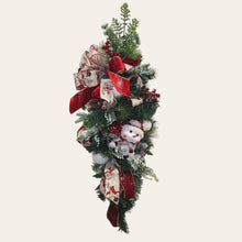 Load image into Gallery viewer, This is a teardrop door hanger that is a festive swag for Christmas season. It has berries, pinecone, snowballs, cute snowman, and a bow.
