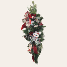 Load image into Gallery viewer, This is a teardrop door hanger that is a festive swag for Christmas season. It has berries, pinecone, snowballs, cute snowman, and a bow.
