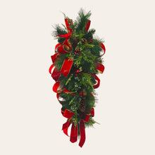 Load image into Gallery viewer, This is a teardrop door hanger festive swag for Christmas season. It has red &amp; blue berries, pinecones, cardinals, and red velvet ribbon.
