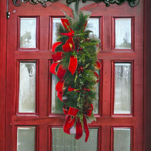 Load image into Gallery viewer, This is a teardrop door hanger festive swag for Christmas season. It has red &amp; blue berries, pinecones, cardinals, and red velvet ribbon.
