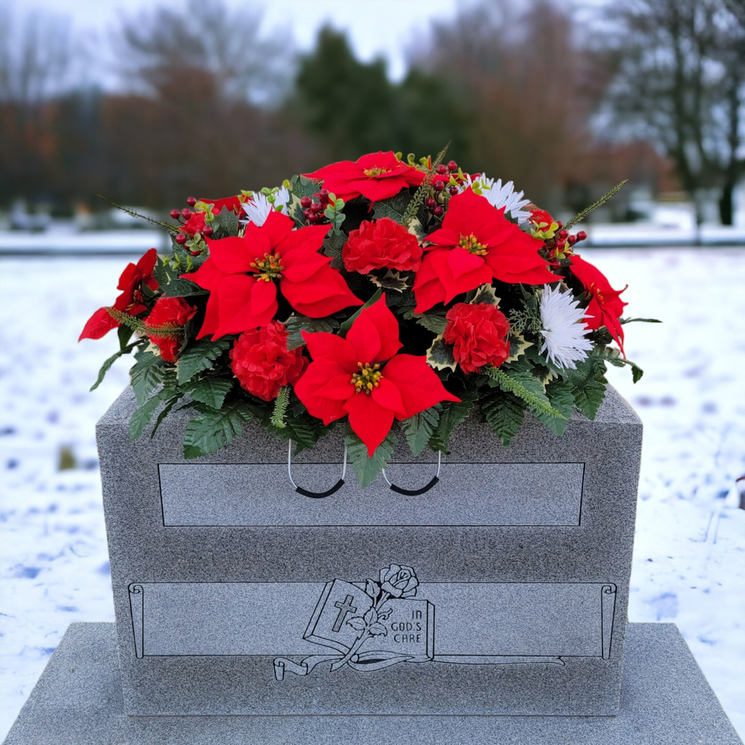 This Headstone Saddle is made with grave flowers including Red and White Poinsettia. It is a perfect winter memorial decoration.