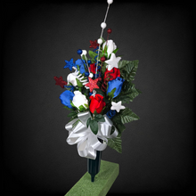 Load image into Gallery viewer, This patriotic memorial cemetery cone pair has grave flowers including red, white, and blue rosebuds and glitter stars.

