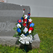 Load image into Gallery viewer, This patriotic memorial cemetery cone pair has grave flowers including red, white, and blue rosebuds and glitter stars.
