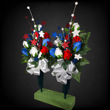 Load image into Gallery viewer, This patriotic memorial cemetery cone pair has grave flowers including red, white, and blue rosebuds and glitter stars.
