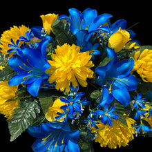 Load image into Gallery viewer, This Headstone Saddle has grave flowers including Vibrant Blue Trumpet Lilies, Bright Yellow Mums, &amp; Rosebuds. It is a memorial decoration.
