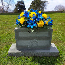 Load image into Gallery viewer, This Headstone Saddle has grave flowers including Vibrant Blue Trumpet Lilies, Bright Yellow Mums, &amp; Rosebuds. It is a memorial decoration.
