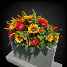 Load image into Gallery viewer, This Headstone Saddle is made with grave flowers including Yellow and Red Sunflowers. It's a summer or fall memorial decoration.
