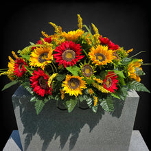 Load image into Gallery viewer, This Headstone Saddle is made with grave flowers including Yellow and Red Sunflowers. It's a summer or fall memorial decoration.
